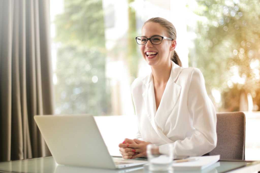 woman laughing because she is so happy from the tax advice she received